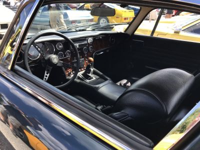 Vintage interior with classic dashboard, gauges, steering wheel, and leather seats