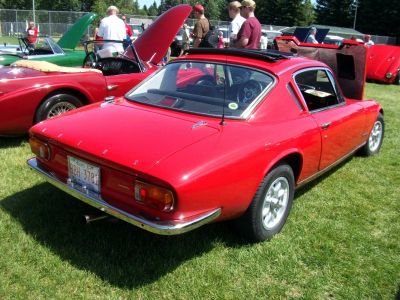 Rear view of a classic Lotus coupe with distinct tail lights.