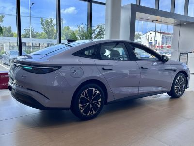 Sleek electric sedan with LED rear light bar and aerodynamic smooth curves.