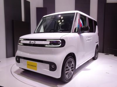 Compact electric urban vehicle with distinctive LED front lights and boxy design