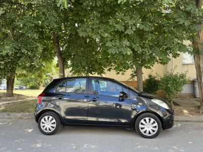 Compact five-door black hatchback side profile with alloy wheels