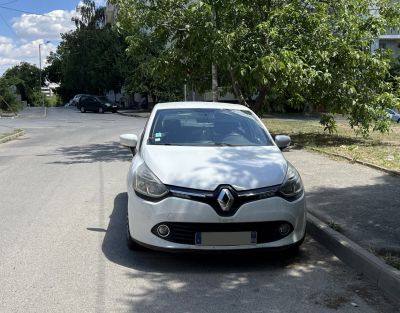 Front view of a compact car with distinctive headlights and grille.