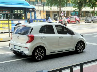 Rear and side view of white compact hatchback with alloy wheels
