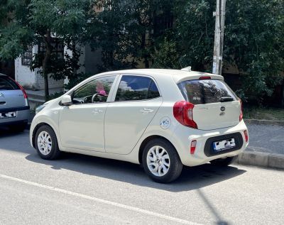 Rear side view of a compact hatchback car with distinctive rear lights.