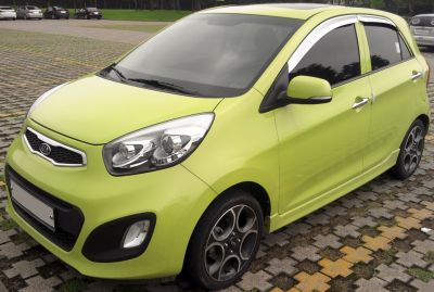 Bright green compact hatchback with alloy wheels and modern headlights