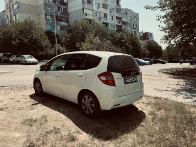 Rear-side view of white hatchback with alloy wheels