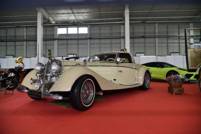 Vintage convertible with chrome headlights and wire wheels