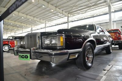 Classic 1970s muscle car front with chrome grille and dual rectangular headlights