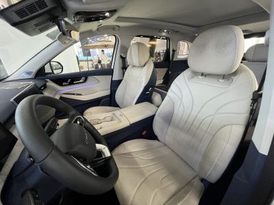 Luxury leather front seats and modern dashboard with ambient lighting