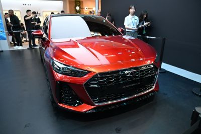 Front view of sedan with aggressive headlights and honeycomb grille