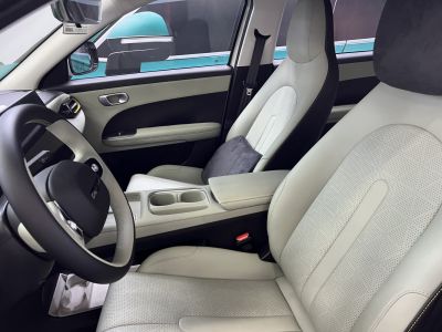 Modern perforated leather seats and steering wheel inside a vehicle