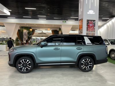 Matte teal SUV with black two-tone roof and alloy wheels