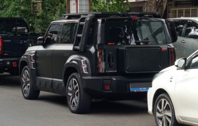 Rear and wheel design of a black SUV with rugged styling and distinct taillights