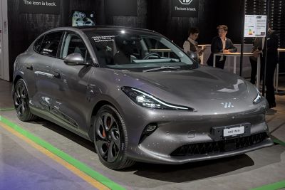 Aerodynamic electric sedan with sharp LED headlights and alloy wheels.