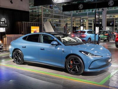 Sleek electric sedan with unique black wheels and orange brake calipers