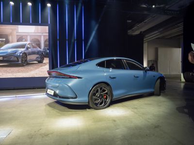 Rear profile of modern electric sedan with sleek design and alloy wheels