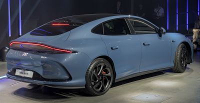 Rear side profile with continuous rear light strip and black alloy wheels
