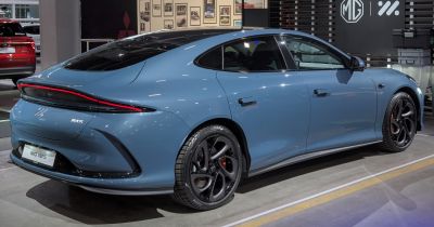 Rear aerodynamic design with full-width LED taillight and black multi-spoke alloy wheels