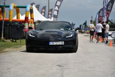 Front view of a sleek black sports coupe with distinct headlights.