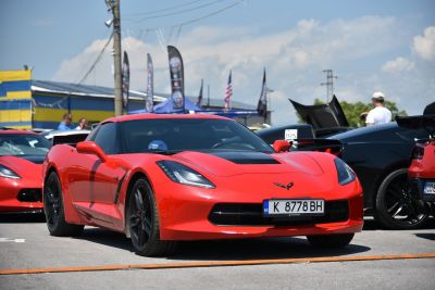 Red sports coupe with sleek headlights and black wheels