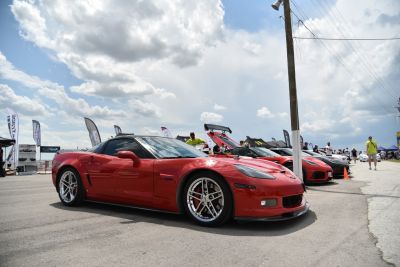 Red sports coupe with polished wheels and aerodynamic front side design