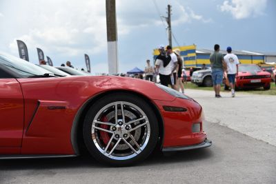 Close-up of front wheel and side vent with sporty alloy rim and brake disc.