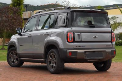 Rear and side view of compact SUV with roof rack and unique taillights