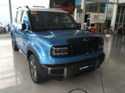 Electric SUV front view with headlights and charging port