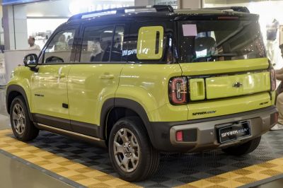 Two-tone yellow and black rear side view with distinctive rear lights and bumper