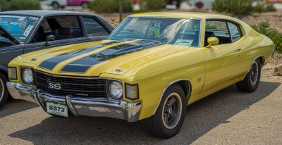 Yellow muscle car with black hood stripes and SS badging