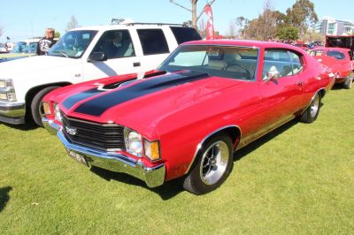 Red 2-door muscle coupe with black hood stripe and SS badge