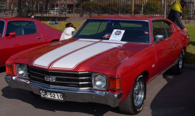 Front view of a classic muscle car with SS grill and dual white hood stripes