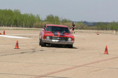 Front view of muscle car with racing stripes and SS badge