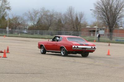 Red muscle sport coupe rear outside view mid-turn