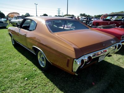 Rear view of classic muscle car with quad tail lights and chrome bumper