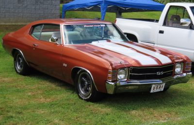 Muscle car with dual racing stripes, SS badge, and classic hood pins