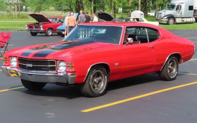 Red muscle coupe with black racing stripes and SS emblem