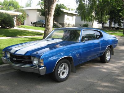Blue 2-door sport coupe with white racing stripes and chrome wheels