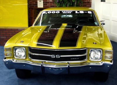 Front view of classic 1970s muscle car with black racing stripes and chrome grille
