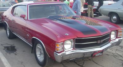 Front view of muscle car with black hood stripes and SS badge