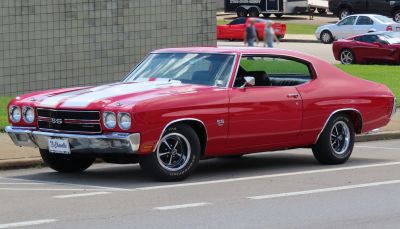 Red muscle coupe with racing stripes and SS 396 emblem