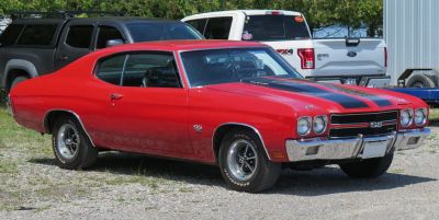 Red 1970 muscle sport coupe with black racing stripes and chrome details