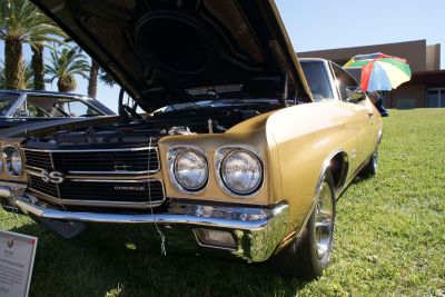 Dual round headlights, chrome grille with SS badge, open hood engine view