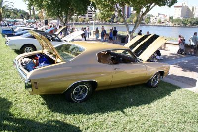 Muscle coupe with hood and trunk open at outdoor car event