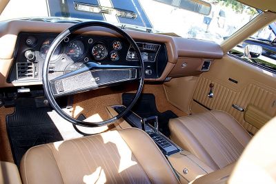Vintage muscle car interior with SS steering wheel and detailed dashboard