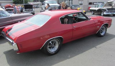 Red sport coupe with rear black racing stripes and SS badge