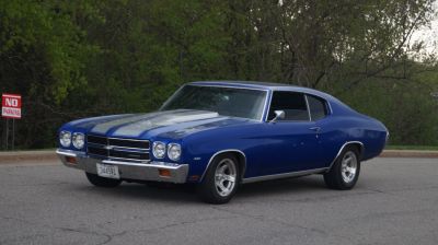 Muscle car with dual racing stripes and hood scoop