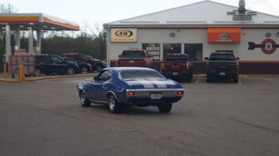 Rear view of muscle coupe with white racing stripes