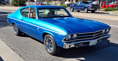 Classic 1960s sport coupe with dual round headlights and side stripe