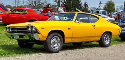 Yellow SS 396 sport coupe with chrome details and classic muscle car design